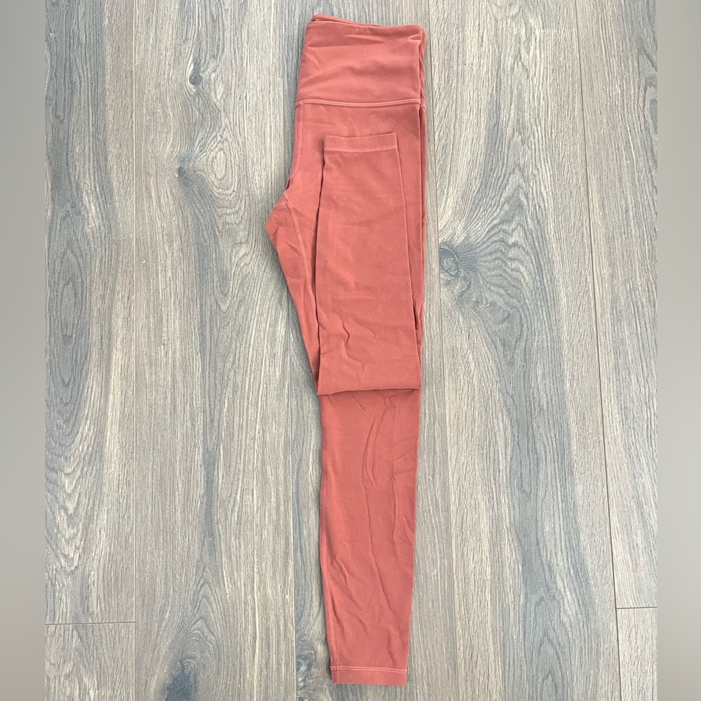 Pink/Salmon colored athlete leggings